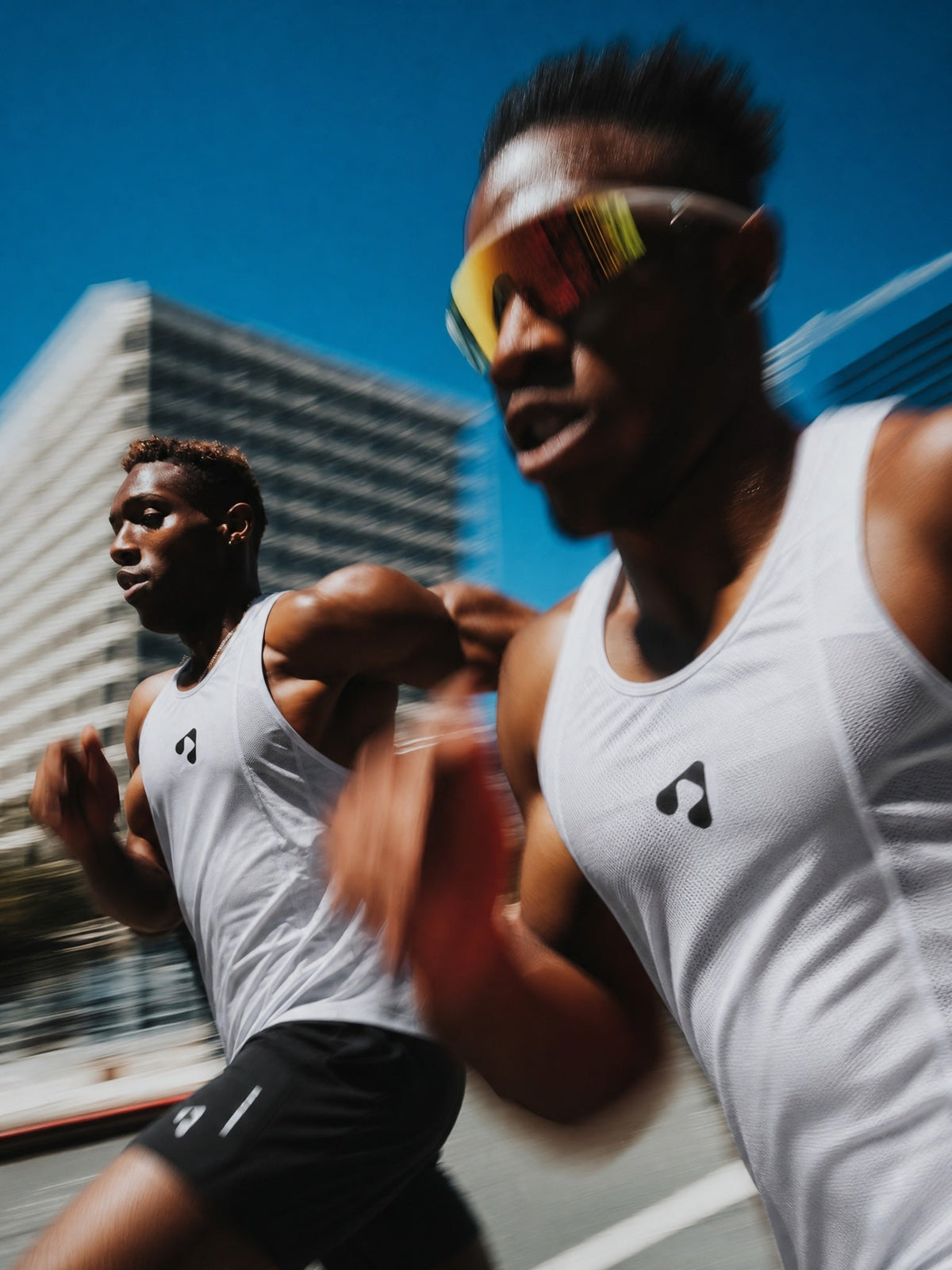 Two runners wearing BoostRunning performance apparel during an outdoor run.