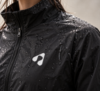 Close-up of water droplets beading on black Boost HYDROX waterproof training jacket