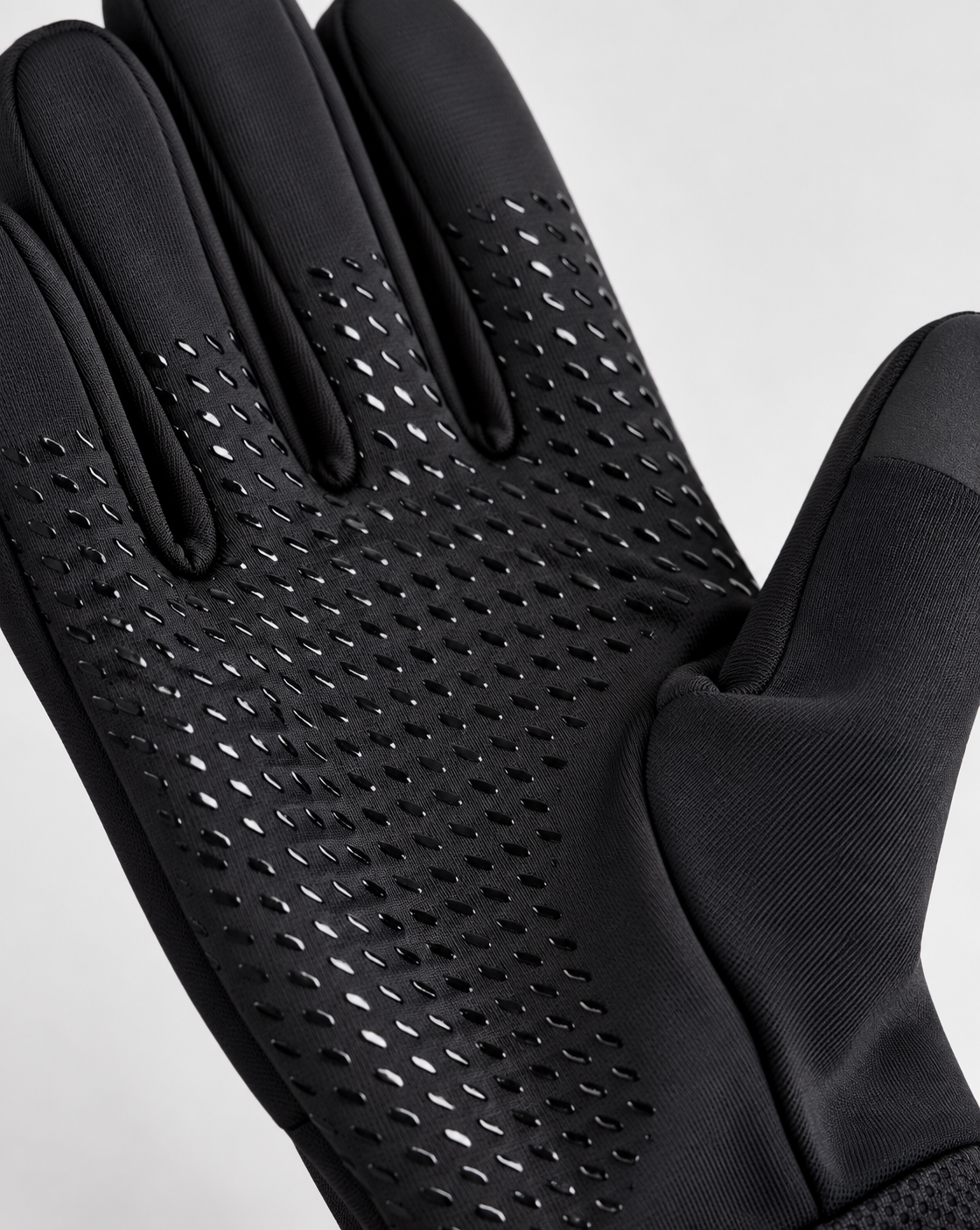 Close-up of anti-slip silicone grip pattern on black glove palm