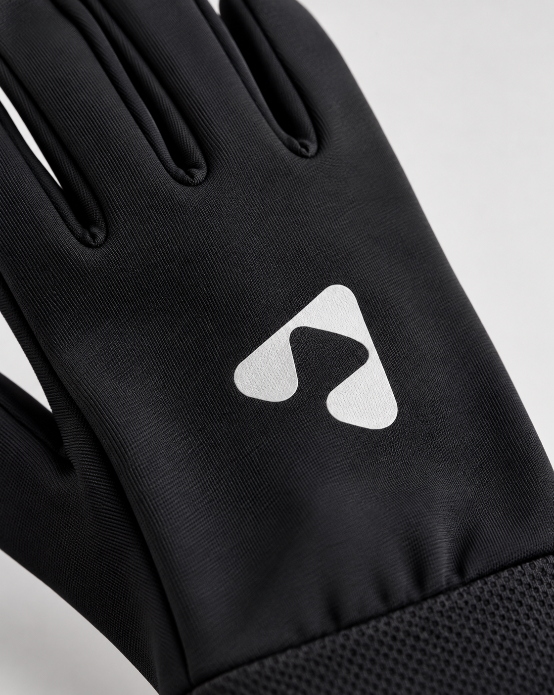 Close-up of white Boost logo on black performance glove